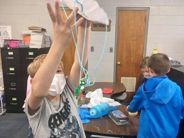 Students create parachutes as part of science unit.